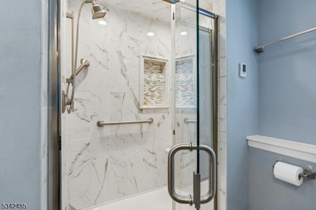 full bath featuring a marble finish shower