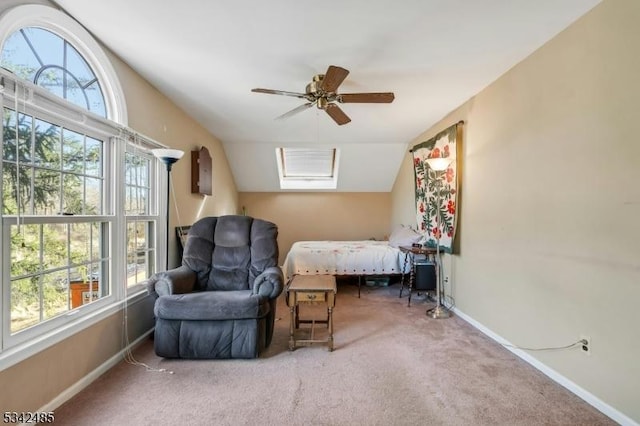 carpeted bedroom with ceiling fan, multiple windows, baseboards, and vaulted ceiling