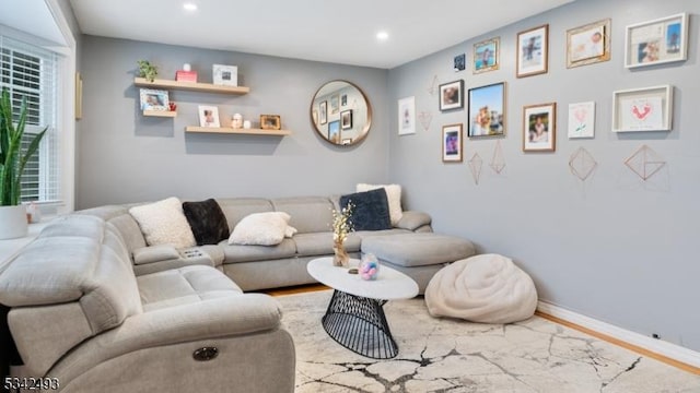 living room featuring recessed lighting, baseboards, and wood finished floors