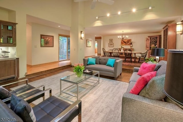5 Apgar Way, Tewksbury Twp, NJ 08833 - living area featuring wood finished floors, rail lighting, ceiling fan, and a chandelier