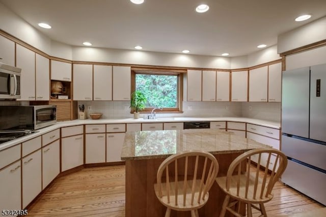 5 Apgar Way, Tewksbury Twp, NJ 08833 - kitchen with appliances with stainless steel finishes, light wood-style flooring, backsplash, a kitchen breakfast bar, and recessed lighting
