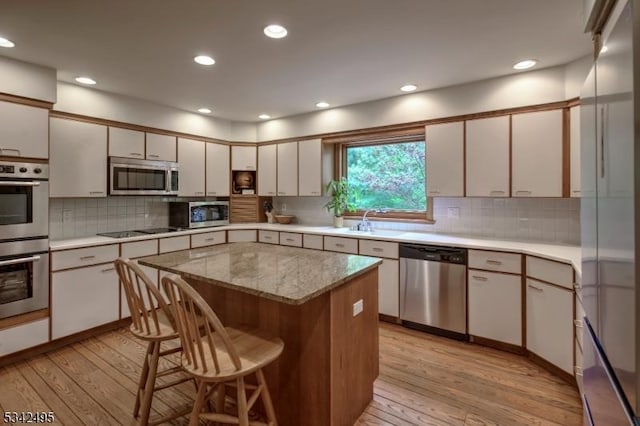 5 Apgar Way, Tewksbury Twp, NJ 08833 - kitchen featuring appliances with stainless steel finishes, light wood-style flooring, a sink, a kitchen breakfast bar, and recessed lighting
