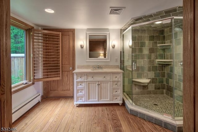 5 Apgar Way, Tewksbury Twp, NJ 08833 - bathroom with a baseboard heating unit, vanity, wood finished floors, a stall shower, and recessed lighting