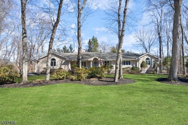 ranch-style house featuring a front lawn