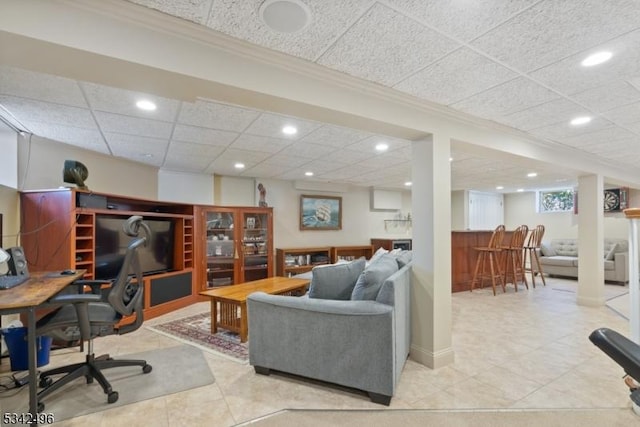 living room featuring a drop ceiling, ornamental molding, tile patterned floors, a bar, and recessed lighting