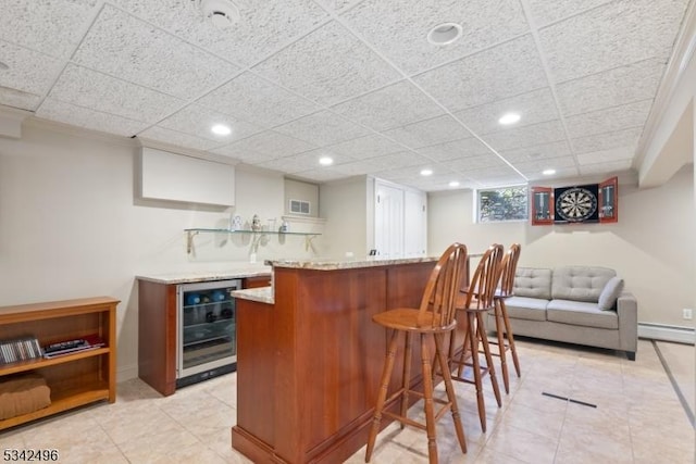 bar featuring indoor wet bar, a baseboard radiator, recessed lighting, visible vents, and beverage cooler