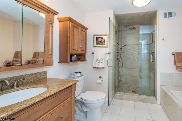 bathroom with visible vents, toilet, tile patterned floors, tiled tub, and a shower stall