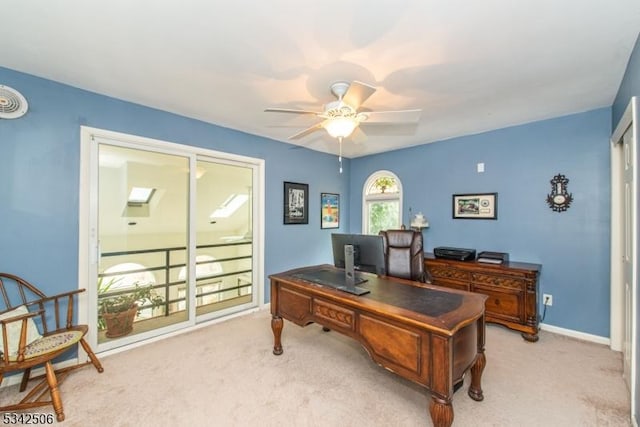 office area with ceiling fan, baseboards, and light colored carpet