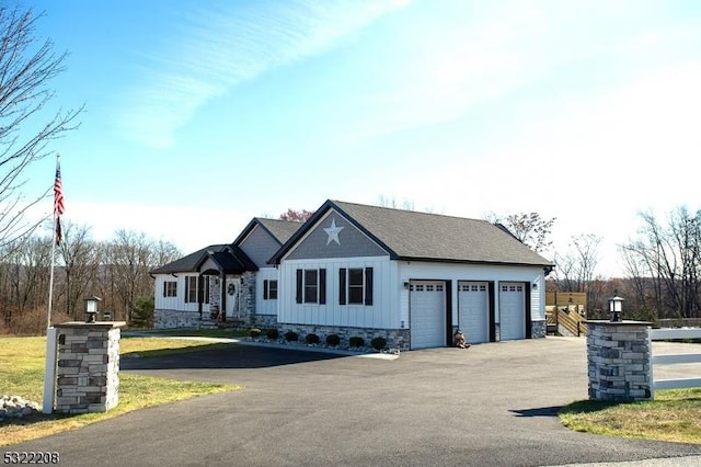 view of front facade with driveway, a garage, board and batten siding, and a front yard