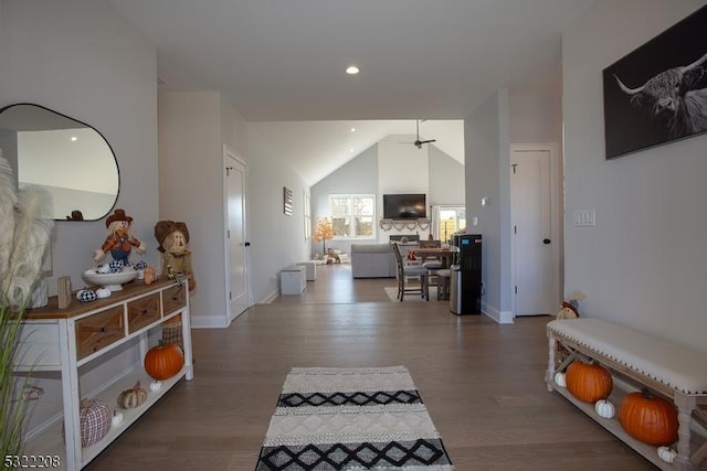 hall with lofted ceiling, recessed lighting, wood finished floors, and baseboards