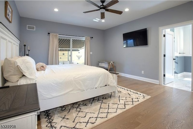 bedroom featuring baseboards, light wood finished floors, visible vents, and recessed lighting