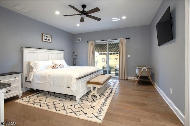 bedroom with recessed lighting, visible vents, wood finished floors, access to outside, and baseboards