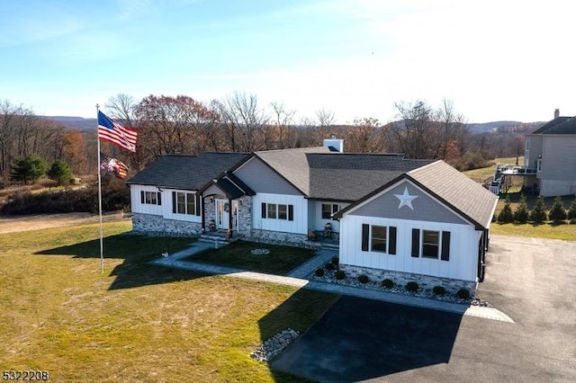 view of front of home with board and batten siding and a front yard