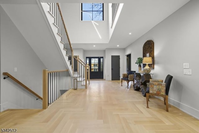 foyer featuring stairway, recessed lighting, a towering ceiling, and baseboards