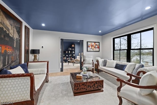 living room featuring recessed lighting, baseboards, and wood finished floors