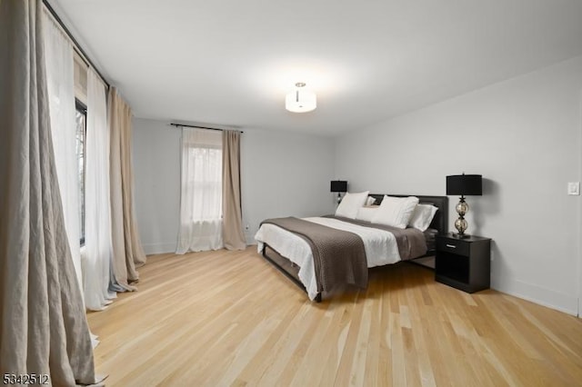 bedroom featuring wood finished floors and baseboards