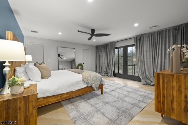 bedroom with access to outside, french doors, wood finished floors, and visible vents