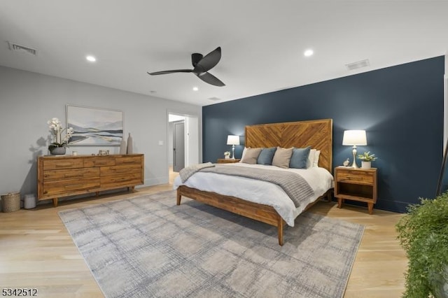 bedroom with light wood-style flooring, a ceiling fan, visible vents, and recessed lighting