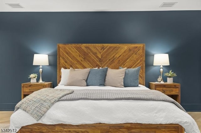 bedroom featuring visible vents and baseboards