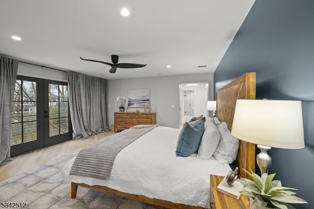 bedroom with connected bathroom, wood finished floors, access to outside, french doors, and recessed lighting