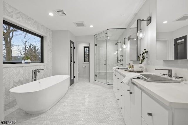 full bathroom featuring visible vents, a shower stall, and vanity