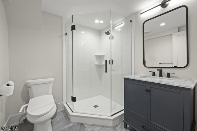 bathroom with baseboards, toilet, marble finish floor, vanity, and a shower stall