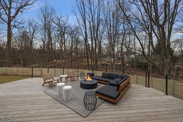 deck with an outdoor fire pit and fence