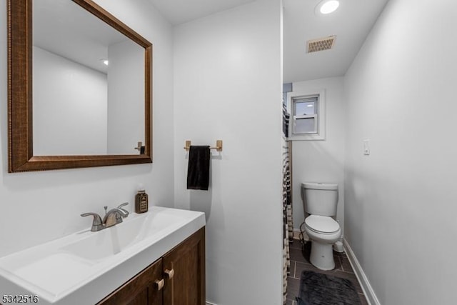 bathroom featuring visible vents, baseboards, toilet, recessed lighting, and vanity