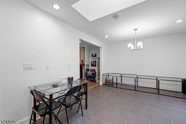 dining area with a skylight, recessed lighting, and a chandelier