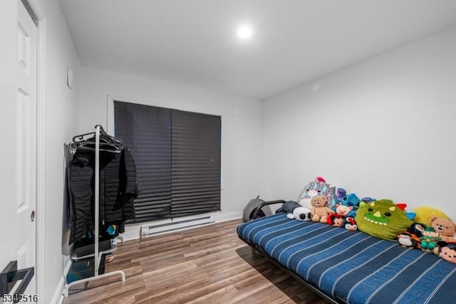 bedroom with baseboards and wood finished floors