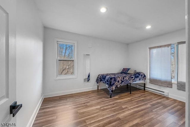 sitting room with recessed lighting, wood finished floors, baseboards, and a baseboard radiator