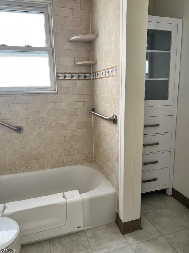 full bath with tile patterned flooring, toilet, and baseboards