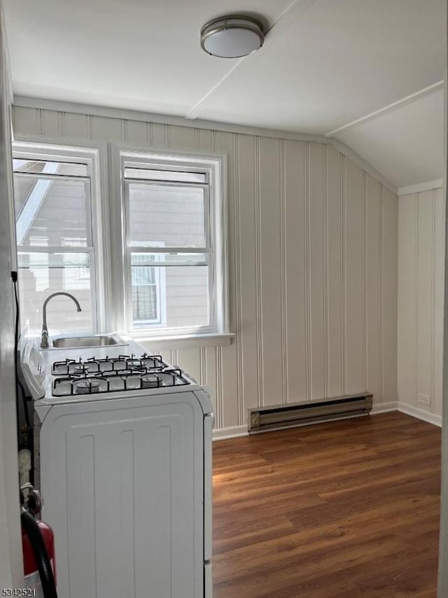 interior space featuring a baseboard heating unit, gas stove, and dark wood-style floors