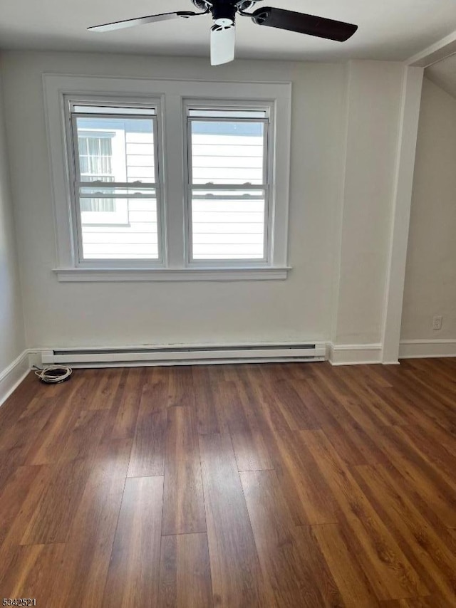 unfurnished room featuring a ceiling fan, a baseboard heating unit, baseboards, and wood finished floors