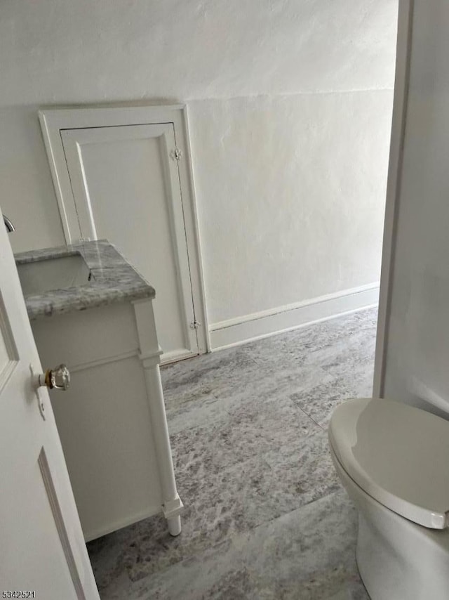 half bath with vanity and toilet