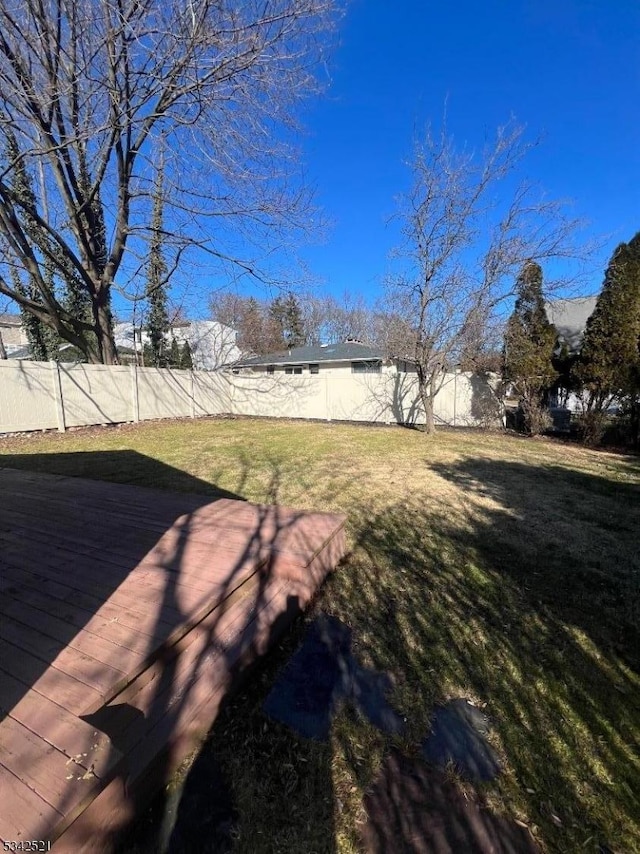 view of yard featuring a fenced backyard and a deck