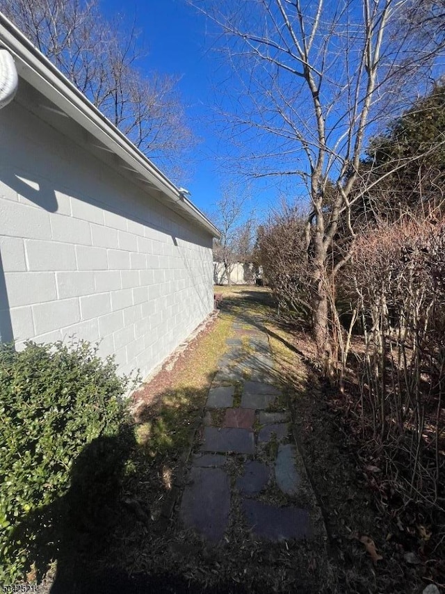 view of side of home with concrete block siding