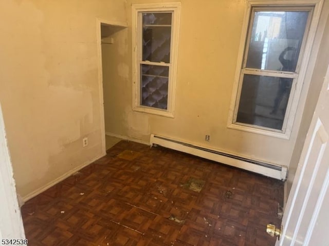 spare room with a baseboard radiator and baseboards