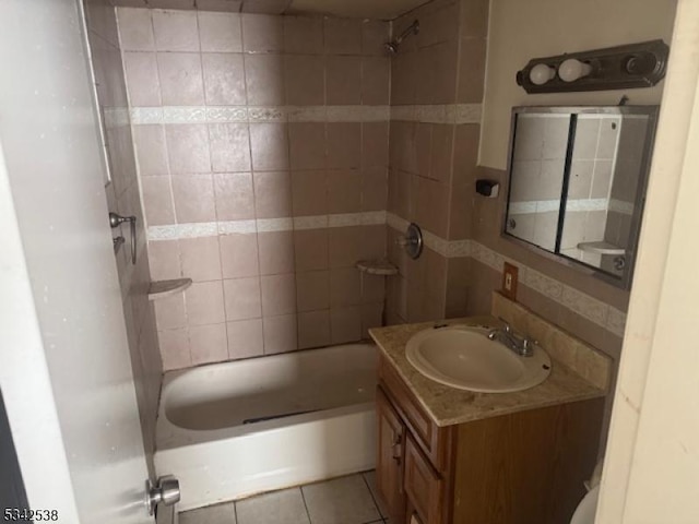 bathroom with  shower combination, vanity, and tile patterned floors