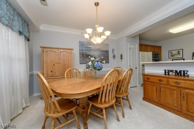 dining space with a notable chandelier, baseboards, visible vents, and ornamental molding