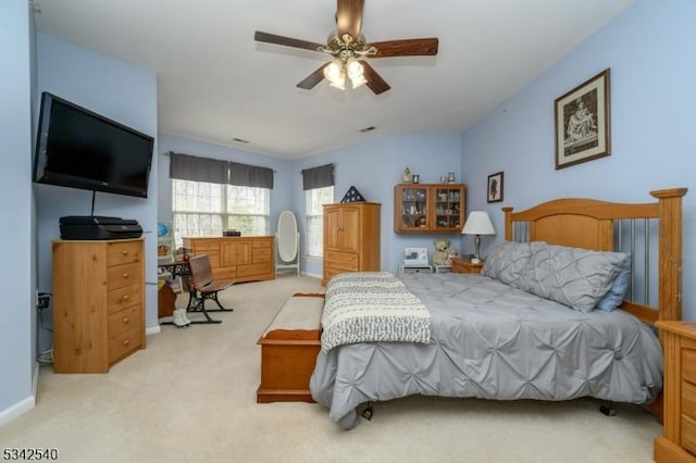 carpeted bedroom with baseboards and ceiling fan