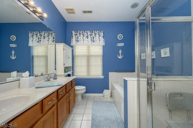 bathroom with tile patterned flooring, double vanity, visible vents, and a sink