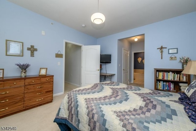 bedroom featuring baseboards, light carpet, and connected bathroom