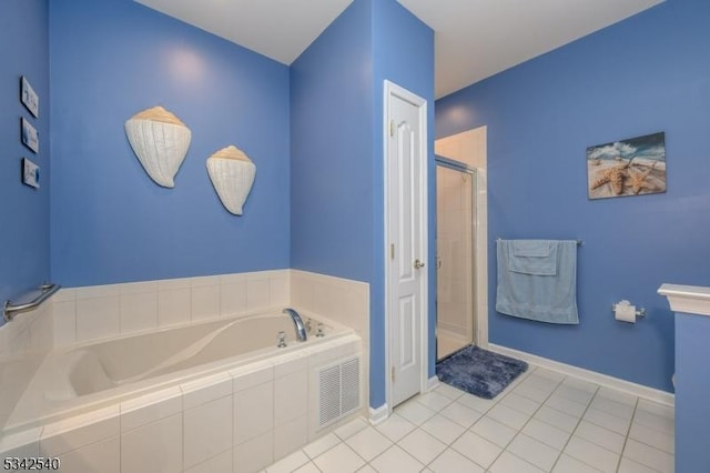 bathroom featuring tile patterned flooring, visible vents, a shower stall, baseboards, and a garden tub