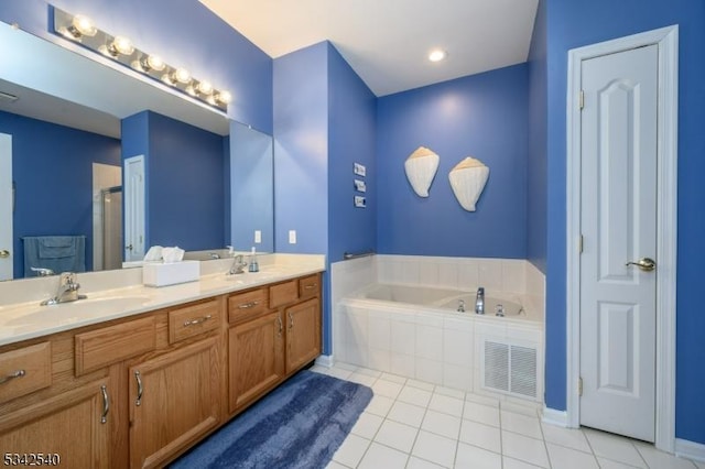 bathroom with visible vents, a sink, tile patterned flooring, double vanity, and a bath