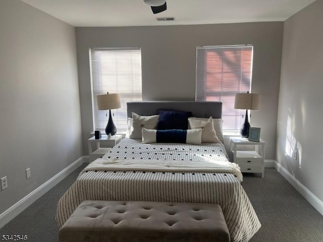 carpeted bedroom with visible vents and baseboards