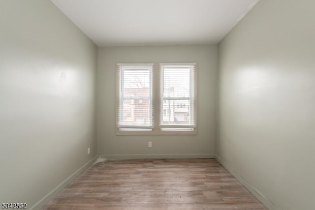 unfurnished room featuring light wood finished floors and baseboards