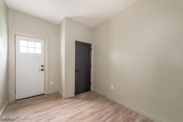 entrance foyer with light wood-style flooring and baseboards