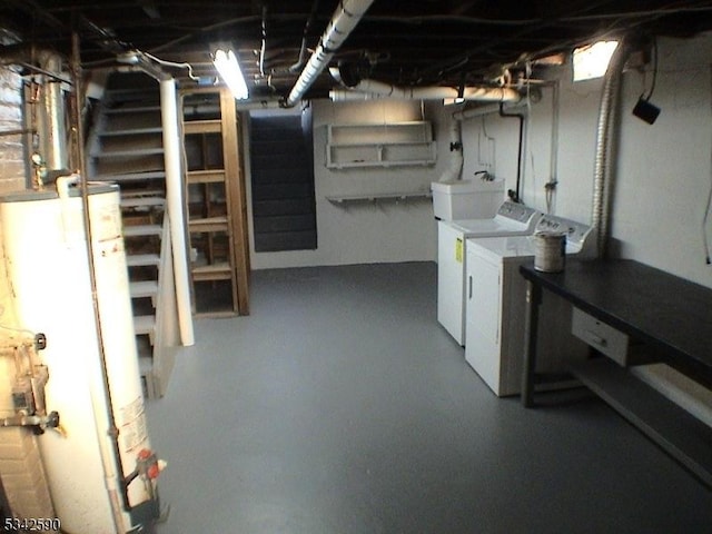 unfinished below grade area featuring water heater, a sink, and washing machine and clothes dryer