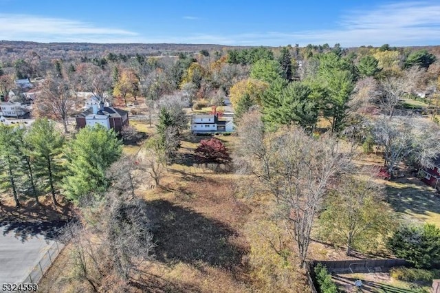 bird's eye view featuring a wooded view